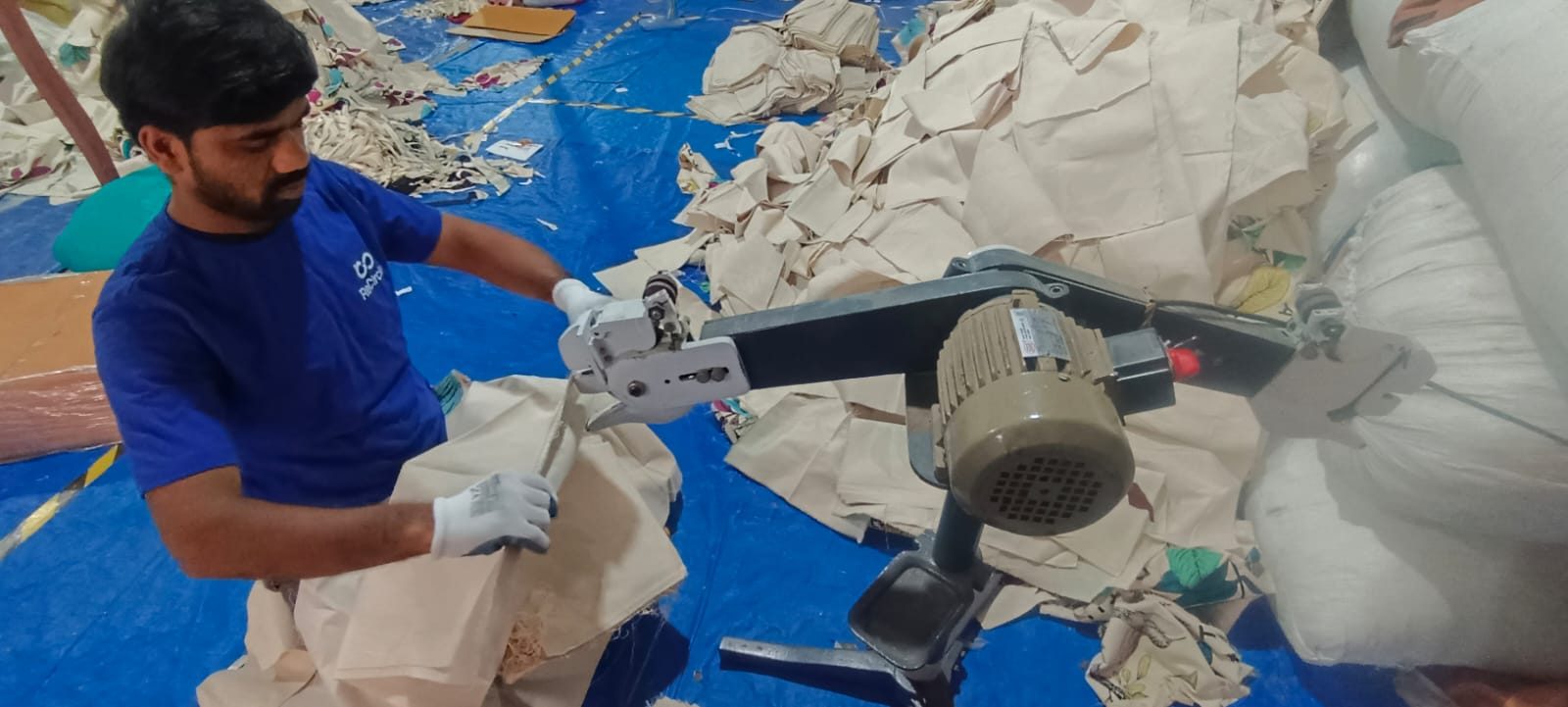 A ReCircle worker processing recovered textiles for recycling