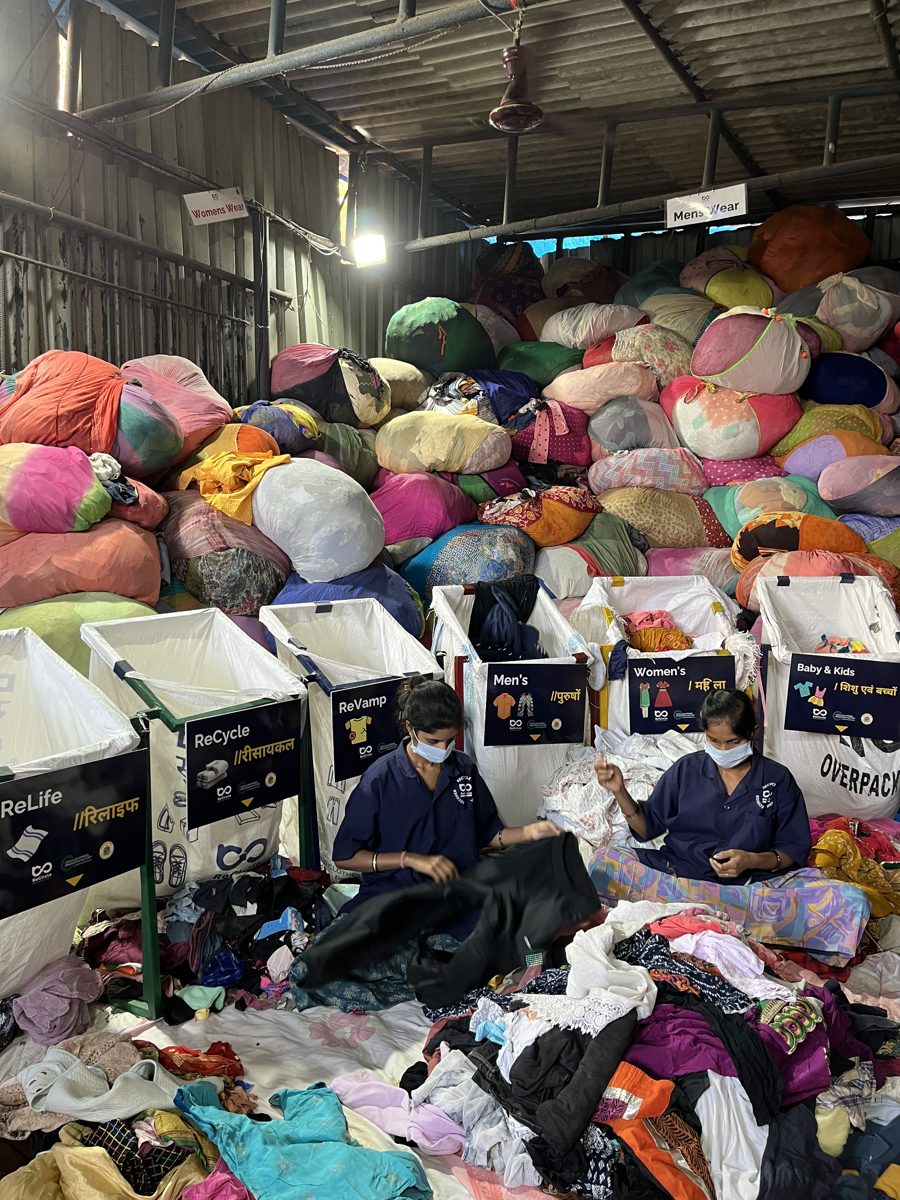 Textiles sorted by category into labelled bins at the recovery facility